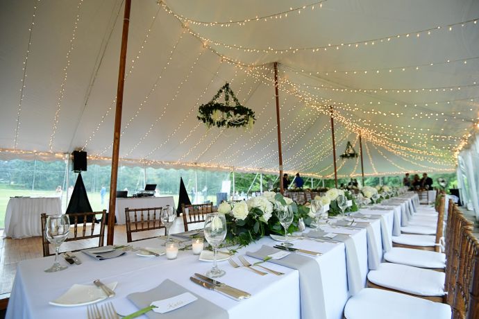 Beautiful outdoor wedding venue with elegant decorations and lake view.