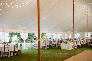 Charming sunset-lit outdoor wedding setup with adorned tables and chairs, perfect for celebrating love.